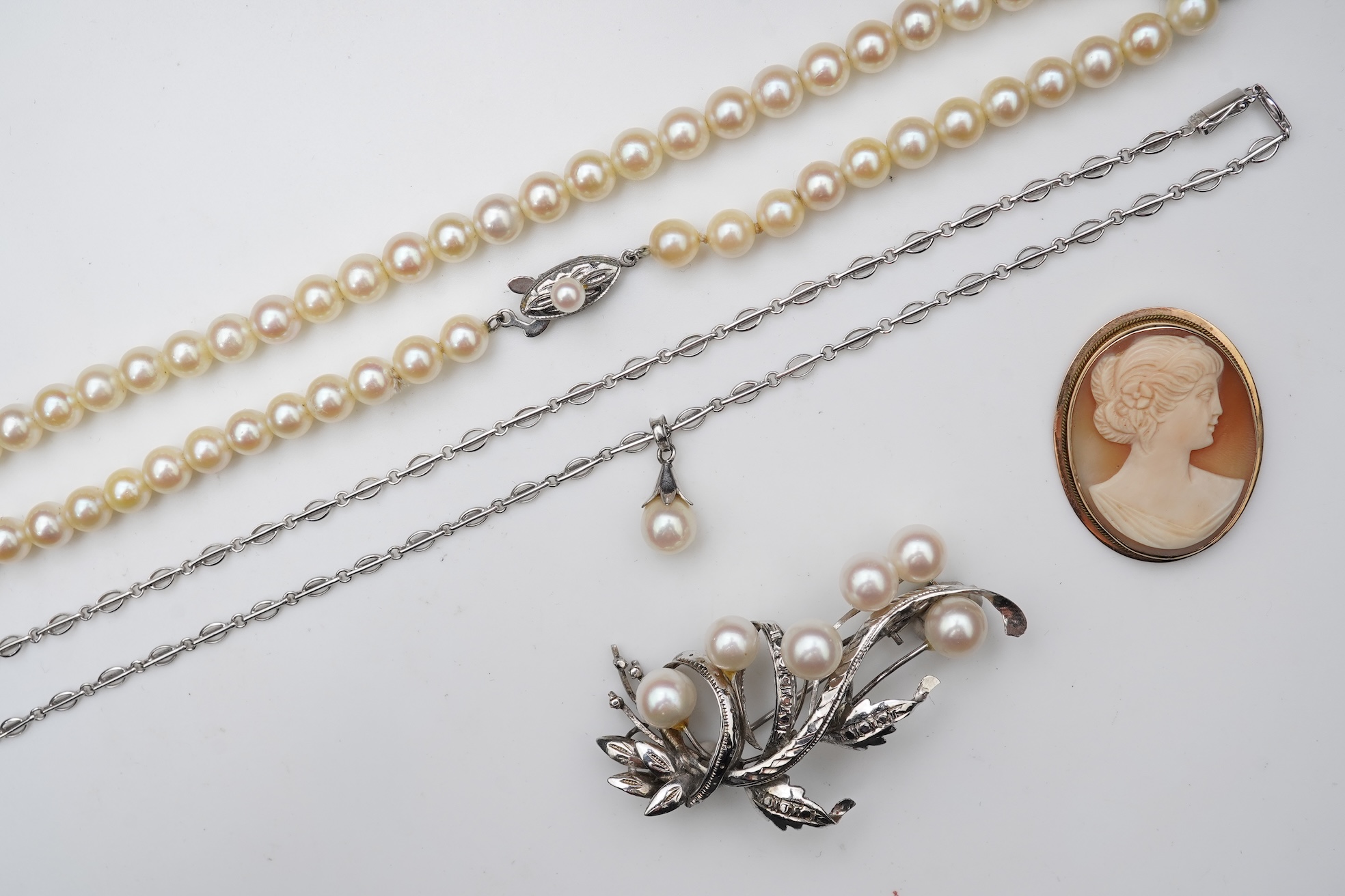 A collection of cultured pearl jewels and a cameo pendant